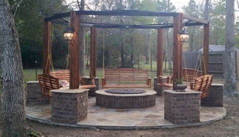 An Outdoor Fire Pit With Swings And Chairs