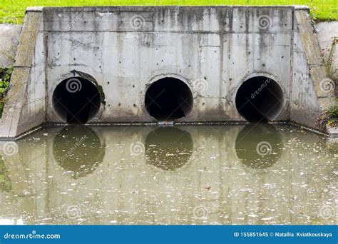 A Drain Pipe Or Sewage Or Sewage Discharges Waste Water Into A River