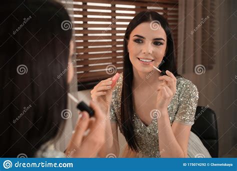 Beautiful Young Woman Applying Makeup Near Mirror Stock ...