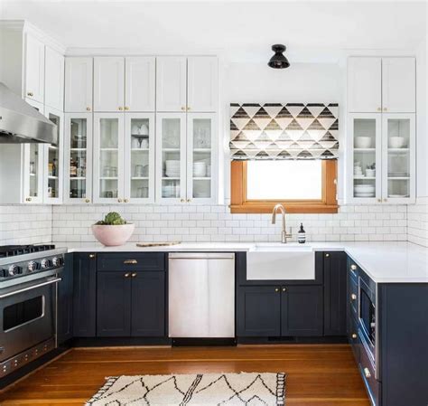 White walls, ceiling and backsplash lighten up the kitchen. An Airy Bohemian Home in Seattle | Rue | Kitchen cabinet design, Navy kitchen cabinets, Kitchen ...