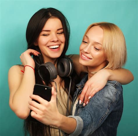 premium photo two girls friends in hipster outfit make selfie on a phone