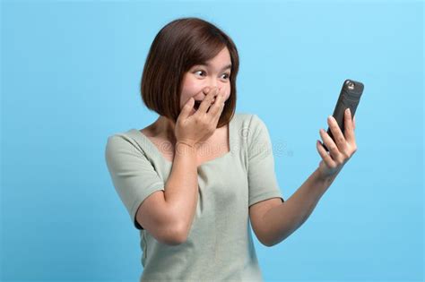 Shock Surprise And Wow Concept Portrait Of Shocked Asian Woman Looking In Mobile Phone And