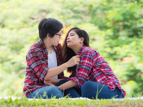 asian female couples lgbt sitting and relax in the garden and embrace each other in love and