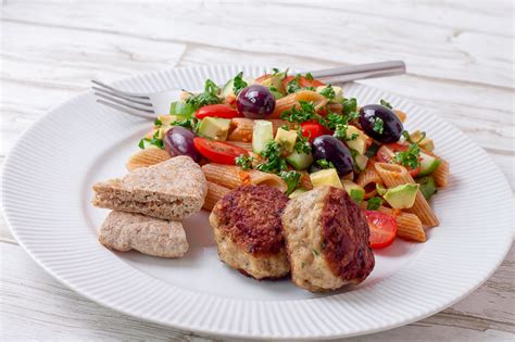 Transfer the cooked meatballs to a clean plate, add another tablespoon of oil, and cook the second batch of meatballs in the same manner. Chicken meatballs with pasta salad and bread