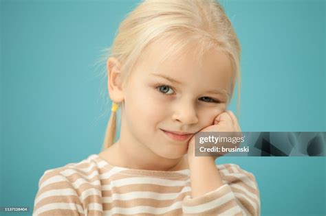Studio Portrait Of A 4 Year Old Blonde Girl On A Blue Background High