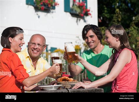 Germany Bavaria Friends Drinking Beer In The Garden Stock Photo Alamy