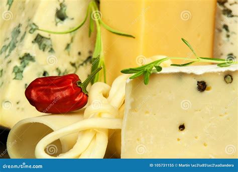 Different Types Of Cheeses On The Kitchen Table Preparation Of Snacks
