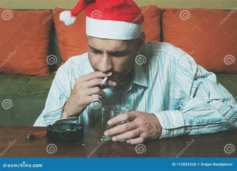 Young Man With Santa Claus Hat Drink Alcohol And Smoking Cigarette