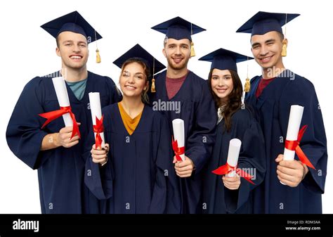 Graduates In Mortar Boards With Diplomas Stock Photo Alamy