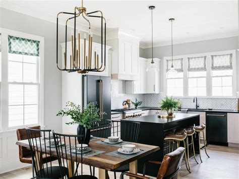 This bright and beautiful modern farmhouse kitchen incorporates a beautiful custom made wood hood with white upper cabinets and a dramatic black base cabinet from kraftmaid. 8 Stylish Tuxedo Kitchen Designs | HGTV