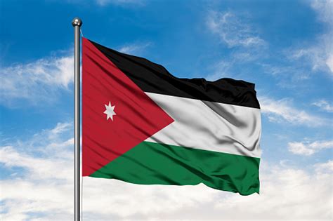 Flag Of Jordan Waving In The Wind Against White Cloudy Blue Sky