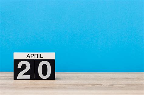 April 20th Day 20 Of Month Calendar On Wooden Table And Blue Background