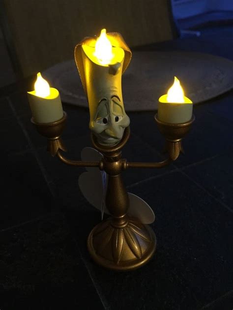 Belle's father owes prince leon money, but can't pay, so he gives him his daughter until he's able to pay. New 2015 Disney Parks Beauty And The Beast Lumiere Candle ...
