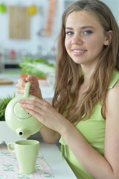 Teen Girl Sitting At White Table And Drinking Tea Stock Image Image