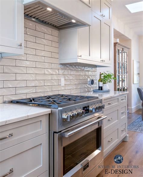 Since grey is one of the most versatile colors, you can use them in any kitchen styles with any colors. Warm gray painted kitchen cabinets with gray subway tile and dark grout and Fulgor stove in ...