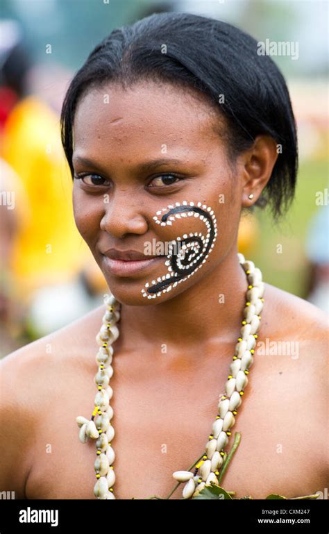 Woman Dressed In Traditional Tribal Costume With Her Face Painted At