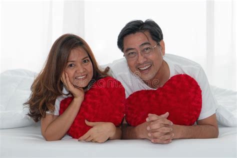 Asian Mature Couple Happy With Romantic Moment Together Under Blanket
