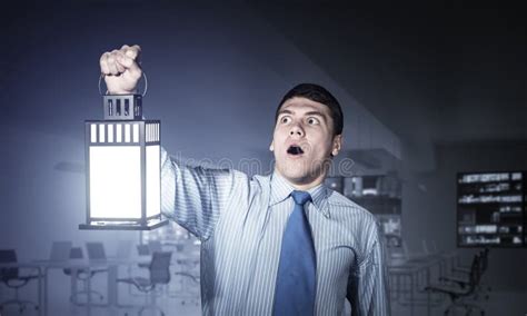 horrified businessman holding glowing lantern stock image image of leadership horrified