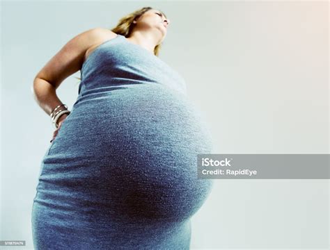 Extremely Pregnant Woman With Aching Back Shot From Low Angle Stock