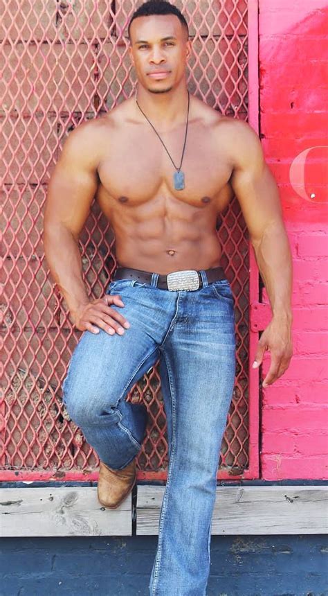 A Shirtless Man Leaning Against A Pink Wall