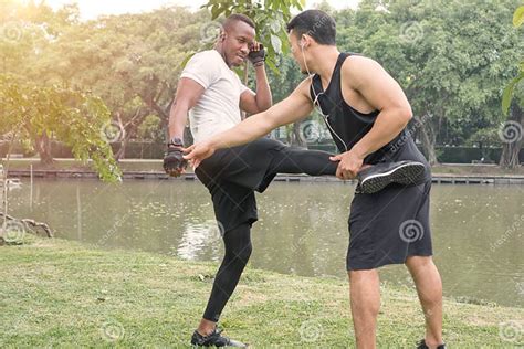 two muscular men exercising together by a river stock image image of fight earphone 217086213
