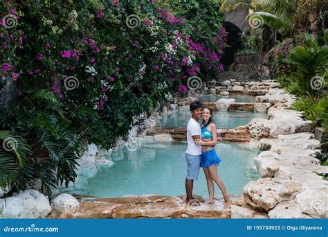 Happy Couple In Love Multiethnic Couple At The Swimming Pool Swimming Pool Surrounded By Pink