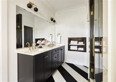 The perception that black vanities work in only polished, modern bathrooms is just a misconception that is being a dark vanity with white marble countertop is a hot favorite among homeowners and those who love warm metallic glint can throw in brass handles and. Black and white striped diagonal tiles complement a black ...