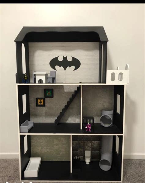 A Dollhouse With A Batman Symbol On The Wall