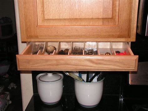 Narrow vertical drawers allow taking such little vertical spaces that you open storage cabinets and railing with pans and pots hanging over them are nice for every kitchen. Silverware drawer Under cabinet Storage and Flatware ...