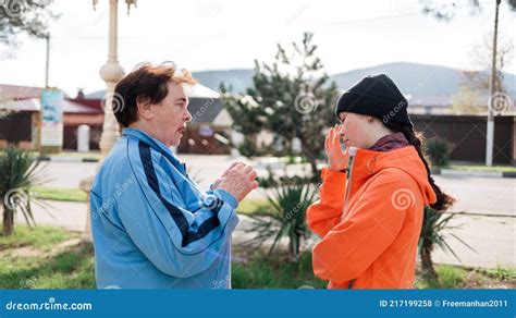 grandmother scolds the adult granddaughter standing on the street negative communication and