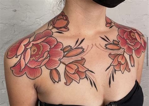 A Woman S Chest With Flowers On It And An Orange Flower In The Middle