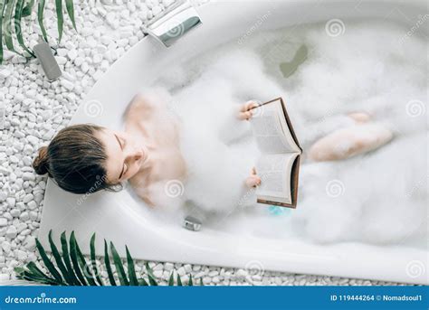 Woman Lying In Bath With Foam And Reads Magazine Stock Photo Image Of