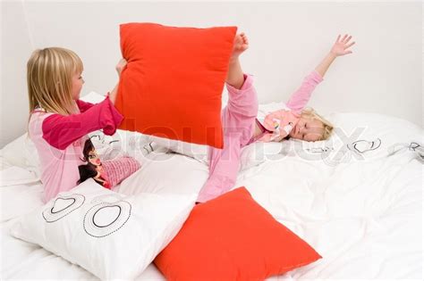 Caucasian Sisters Playing With Pillows Stock Image Colourbox
