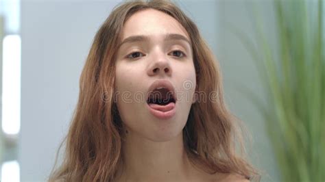 Young Woman With Opened Mouth Looking Tongue And Throat In Mirror In Bathroom Stock Video