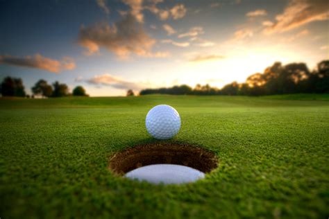 Golf, unlike most ball games, cannot and does not utilize a standardized playing area, and coping with the varied terrains encountered on different courses is a key part of the game.the game at the usual level is played on a course with an arranged. Golf Ball near hole - IPPFA