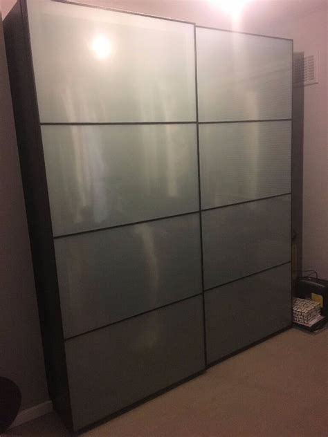 Sliding doors allow more room for furniture because they dont take any space to open. IKEA PAX Wardrobe (black-brown) with frosted glass sliding ...