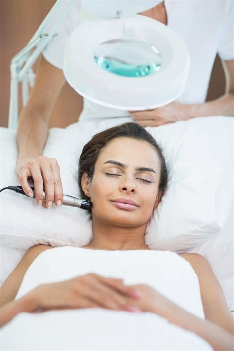 Woman With Eyes Closed While Receiving Facial Massage Stock Image