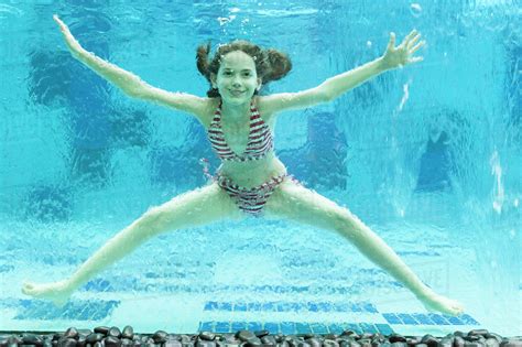 girl swimming underwater  swimming pool stock photo dissolve