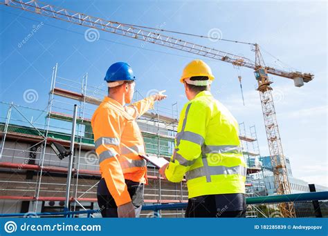 Two Male Engineers Supervising The Construction Site Stock Image