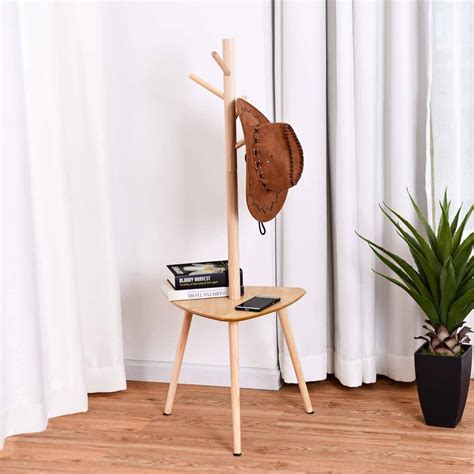 A Hat Rack With Books On It Next To A Potted Plant In Front Of A Window