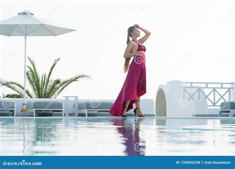 Attractive Girl In Red Dress Posing Near The Pool Stock Photo Image