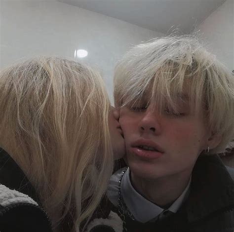 Two Blonde Haired Women Are Kissing Each Other