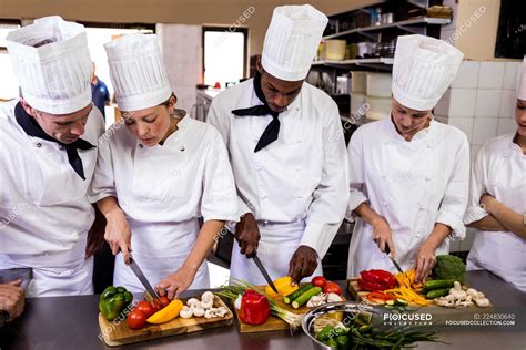 Group Of Chef Chopping Vegetable In Kitchen — Restaurant Teamwork