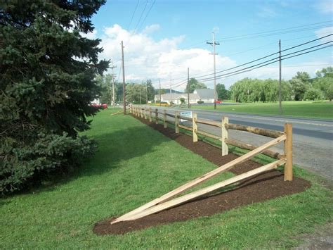 A white picket fence is a classic and iconic choice for residential areas. split rail fence | Fence landscaping, Driveway fence ...
