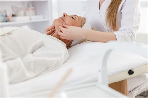 Premium Photo Senior Female Is Lying On Back Getting Face Lifting Massage Facial Massage