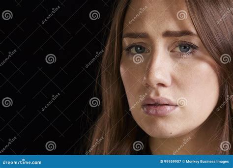 Close Up Head And Shoulders Studio Portrait Of Anxious Woman Stock