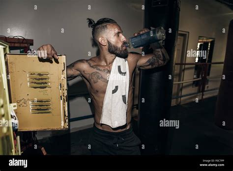 Male Boxer Drinking Water In Gym Locker Room Stock Photo Alamy