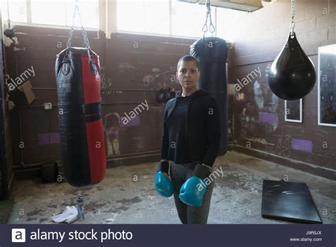 Portrait Confident Tough Female Boxer In Boxing Gloves Near Punching