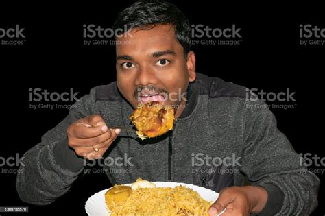 Indian Man Eating Spicy Homemade Biryani Chicken On Black Background