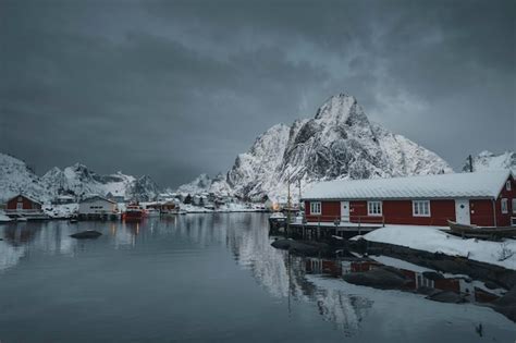 Premium Photo Red Cabins On A Snowy Reine In Moskenesøya Island Norway